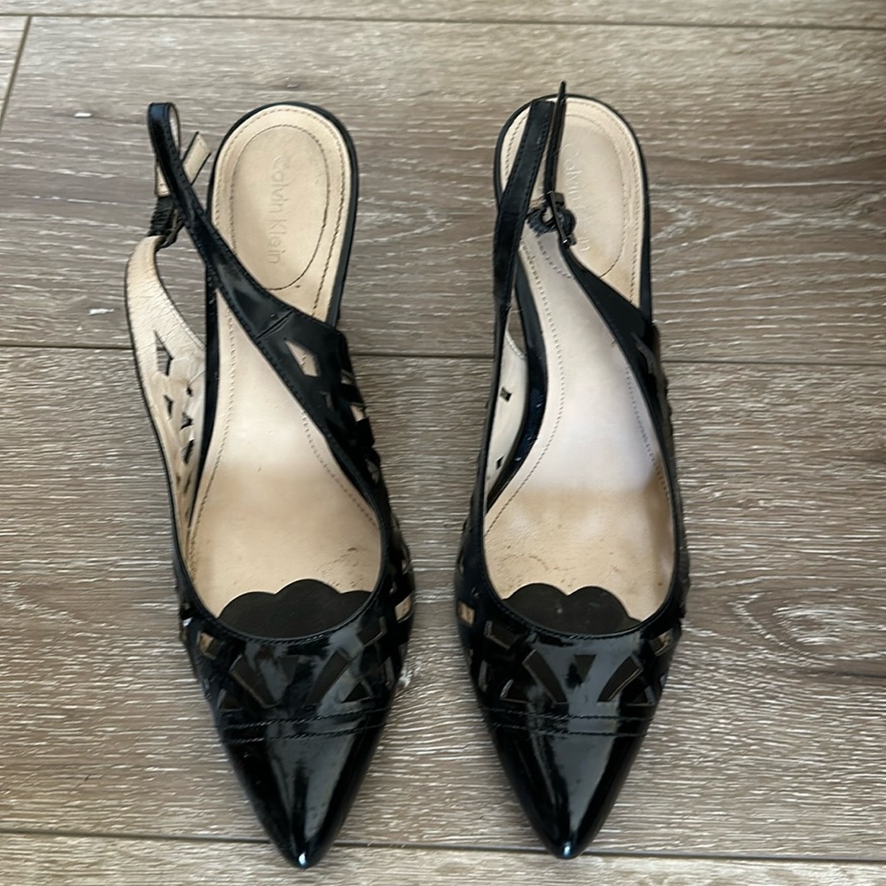 Calvin Klein 8.5 black patent cut out leather pointed toe heel.